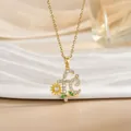 Macro shot of gold necklace featuring letter F pendant with sunflower and zircon stones - Gold Zirconia Letter f Sunflower Pendant (XL1106)