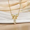 Macro shot of gold bow pendant with zircon-encrusted letter S on a steel necklace - Letter S
