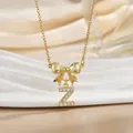 Macro shot of gold bow necklace with letter Z pendant and inlaid cubic zirconia - Letter Z