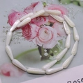 Macro detail of white teardrop shell beads with pearl luster for DIY jewelry making - 4x7mm / White