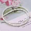 Detailed view of white cylindrical sea shell beads with iridescent luster for DIY jewelry - 3.5x3.5mm, 9g / White