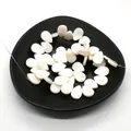 Natural teardrop white shell beads for DIY jewelry making displayed on a black ceramic tray - Horizontal Hole Waterdrop / 10x15mm, 21g