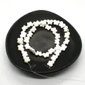 Natural white mother of pearl butterfly beads for DIY jewelry making on black plate - Horizontal Hole Butterfly Shape / 8x12mm, 20g