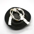 Macro shot of square white mother of pearl loose beads for DIY jewelry making in a black tray - Square