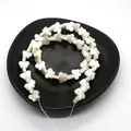 Macro shot of butterfly-shaped natural shell beads in a black tray for DIY jewelry - Butterfly