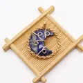 Makroansicht: Handgefertigter, golddrahtumwickelter runder Anhänger mit blauem Lapis-Mond - 42x50mm / Sodalith