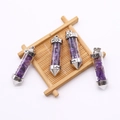 Detail of four purple crystal bullet pendants with Love engraving and heart patterns - Amethyst