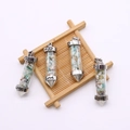 Detail view of bullet-shaped natural stone pendants with Love engraving and silver plating - Amazonite