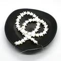 Star-shaped white freshwater shell beads for DIY jewelry making on black plate - Pentagram