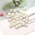 Close-up of round shell beads with gold ampersand symbol for DIY necklace jewelry - & Symbol Pattern / 8mm 20 Pieces Per Pack