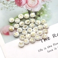 Macro detail of white shell beads with golden butterfly prints on a floral backdrop - Small Butterfly Pattern / 8mm 20 Pieces Per Pack