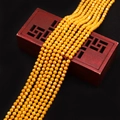 Macro de cuentas de turquesa amarilla facetadas sobre caja de madera roja para joyería DIY - Amarillo Brillante
