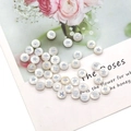 Macro detail of round white pearl shell beads with silver star pattern for DIY jewelry making - Five-Point Star Print / 8mm 20 Pieces Per Pack