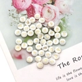 Macro shot of white shell beads with golden Hamsa Hand charms for DIY jewelry making - Palm Print / 8mm 20 Pieces Per Pack