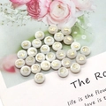 Detailed view of round shell beads with golden Yin Yang pattern on floral background - Yin Yang Tai Chi Pattern / 8mm 20 Pieces Per Pack