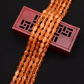 Macro view of translucent orange faceted oval cat-eye stone beads on a wooden box - 4x6MM / No. 8 (Orange)