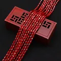 Macro detail of faceted deep red teardrop zircon beads on a decorative wooden box - 4x6MM / Deep Red (No. 5)