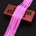 Detail of faceted lavender cubic zirconia beads draped over a vintage wooden jewelry box - Pink Purple (No. 2) / 2.5x2.5mm