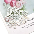 Detailed view of round white shell beads with silver lightning motif for jewelry making - Lightning Print / 8mm 20 Pieces Per Pack