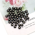 Macro detail of black round shell beads with gold starfish print for DIY jewelry making - Starfish Print / 8mm 20 Pieces Per Pack