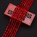 Macro shot of red faceted cat's eye beads draped over an ornate wooden box - 4x6MM / No.4 (Red)