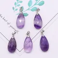 Macro detail of four faceted purple amethyst water drop pendants with silver metal clasps - 13x25mm / Purple Crystal