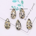 Macro shot of faceted teardrop dalmatian jasper beads for DIY jewelry making - 13x25mm / Dalmatian Jasper