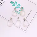 Five transparent teardrop gemstones with silver metal bails on a decorative card - 18x25mm / Transparent Crystal