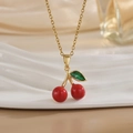 Close-up of a sweet cherry pendant necklace with red fruit and green leaf on gold chain - Red Enamel Cherry Style (XL01169)
