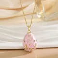 Vintage pink enamel egg pendant necklace with gold patterns and sparkling crystals - Hot Pink