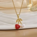Close-up of gold cherry pendant necklace featuring a red heart and a white pearl charm - Red Heart Pearl Cherry Style (XL01177)