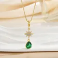 Detailed macro view of a gold star pendant with tiny zircon and a green teardrop gemstone - Octagram Waterdrop Necklace (XL01261)
