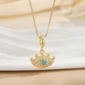 Detailed close-up of gold-plated crown pendant with blue stone and pavé zircon settings - Evil Eye Crown Necklace (XL01270)