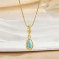 Close-up of a gold-plated teardrop necklace featuring a turquoise stone and beaded trim - Teardrop Turquoise Pendant Necklace (XL01285)