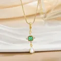 Detailed macro view of gold plated necklace with green emerald and zirconia stones - Square Emerald Cross Star Necklace (XL01291)