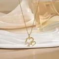Elegant gold double heart necklace with sparkling zircon stones on a silk background - Gold Intertwined Double Heart Rhinestone Style (XL01657)