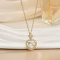 Golden heart pendant necklace with sparkling crystal inlay on white textured background - Rhinestone Encrusted Heart (XL01477)