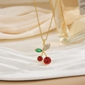 Detail of cherry pendant necklace with red crystals and micro-set green leaves - Red Rhinestone Cherry Style (XL0570)