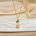 Macro detail of cherry pendant with pearl and micro-pave stones on golden chain - Pearl Metal Ball Cherry Style (XL0593)