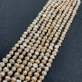 Macro detail of champagne baroque freshwater pearl strands for DIY jewelry making - 3-4mm / Pink