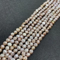 Strands of natural purple baroque freshwater pearls with strong luster on black leather - 3-4mm / Purple