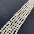 Lustrous white freshwater pearls for DIY jewelry making on dark textured background - 3-4mm / White