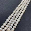 Strands of white 6-8mm freshwater pearls on black background for DIY jewelry - 4-5mm / White