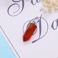 Detail of red agate hexagonal prism pendant with polished natural stone texture - 9x28mm / Red Agate