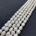 Macro detail of natural freshwater baroque pearl strands with iridescent white luster - 5-6mm 10g / White
