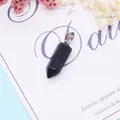 Blue sandstone hexagonal pillar pendant with a silver bail on a decorative floral background - 9x28mm / Blue Sandstone