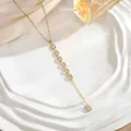 Detail of 18K gold Y-necklace with micro-pave zircon square modules on ceramic tray - Seven Pave Square Module Style (XL01927)