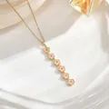 Long tassel necklace featuring six pink floral pendants on a gold chain detail - Six Pink Enamel Flower Style (XL01929)