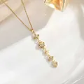 Detailed shot of gold tassel necklace featuring star, moon, and butterfly cubic zirconia pendants - Heart Star Butterfly Multi-Charm Style (XL01935)