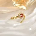 Close-up of gold tulip ring with red opal stone and sparkling zircon accents - Red Tulip Style (JZ0471A)